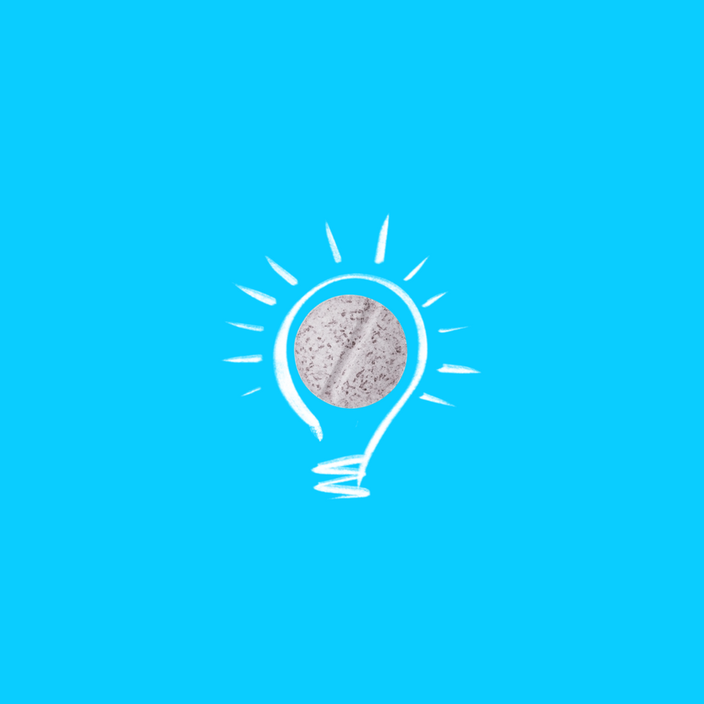 Illustration of a speckled antioxidant booster pill depicted as a lightbulb on a bright blue background, symbolizing brain support from vitamin A, C, and E.