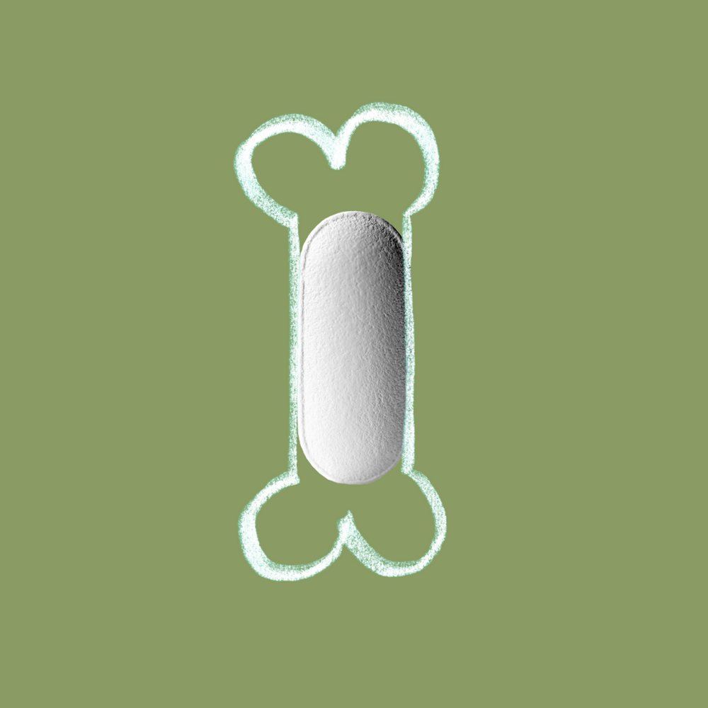 White capsule with a chalk-drawn bone shape on a muted green background, symbolsing bone and joint support of  chondroitin and vitamin C.