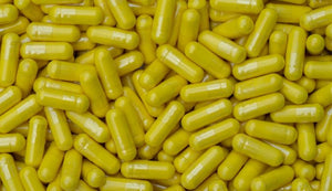 Vivid yellow berberine capsules clustered together, highlighting the supplement's use for glucose metabolism and cardiovascular health support.